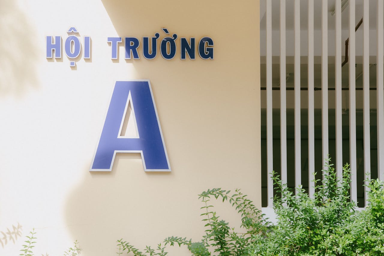 Exterior view of Hội Trường Building A in Hồ Chí Minh, Vietnam, with greenery.