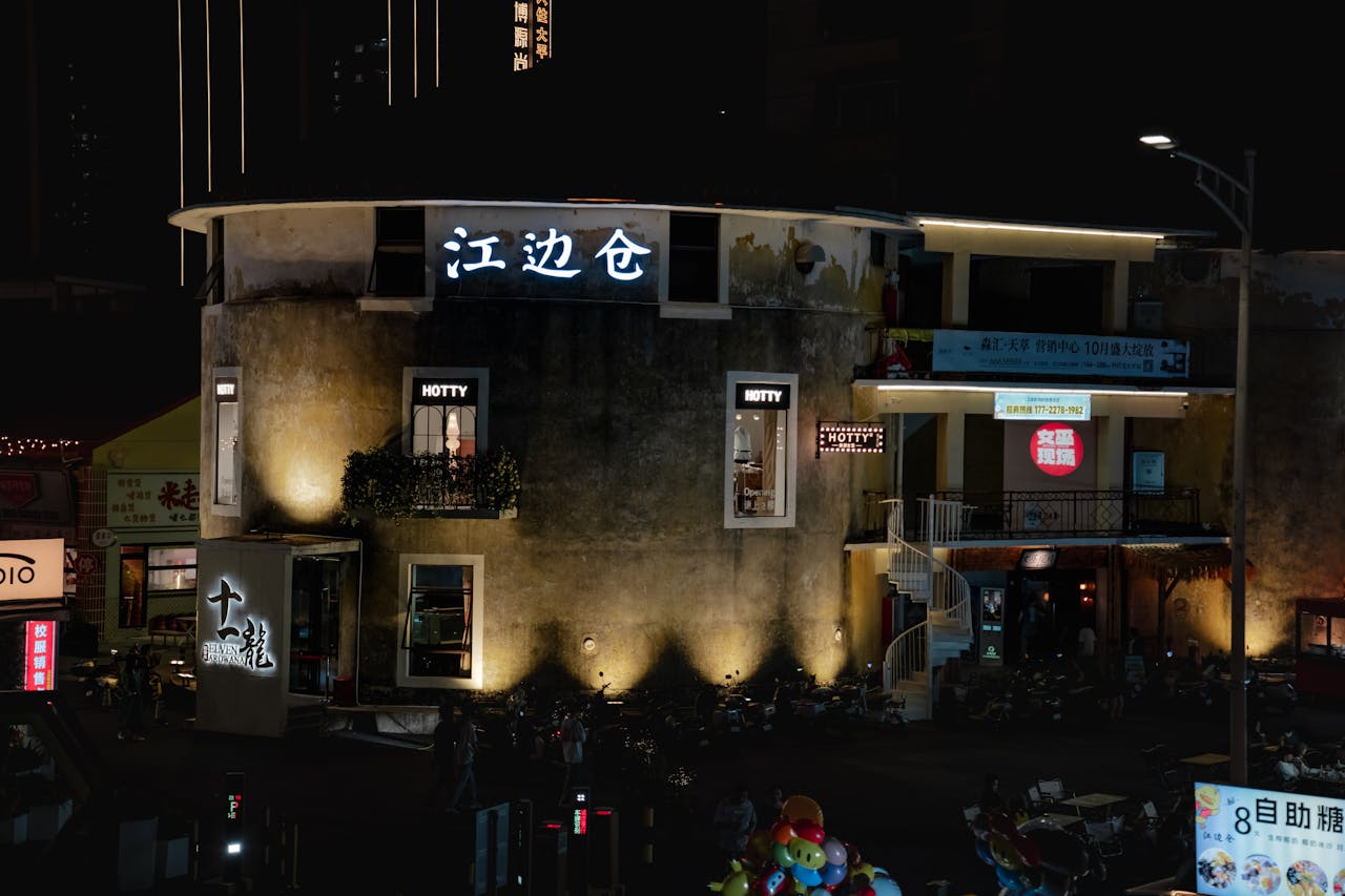 A vibrant night scene showcasing illuminated shops in Foshan, China.